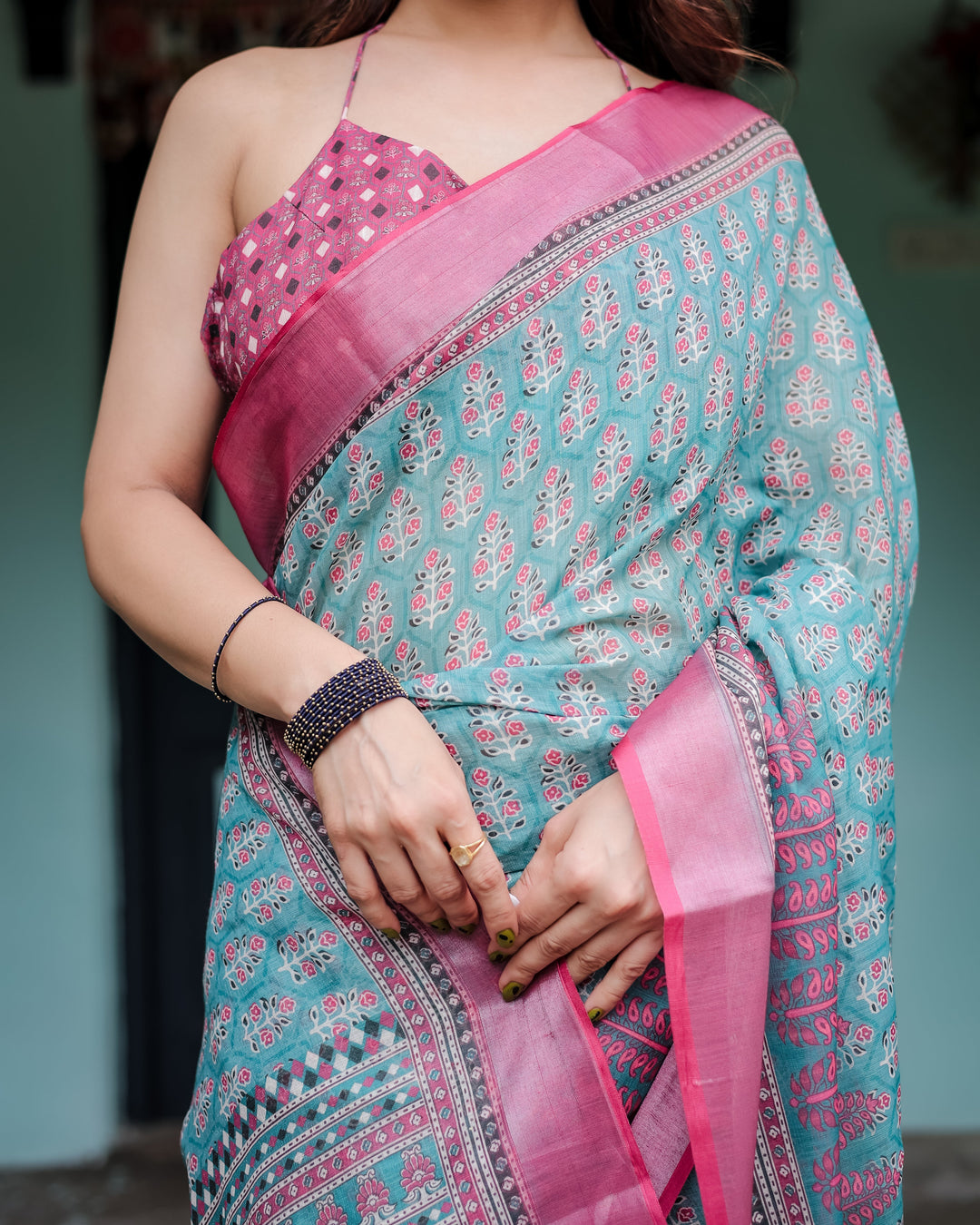 Aqua Blue Pure Cotton Linen Saree with Pink Border, Floral Motifs, and Tassel Detailing