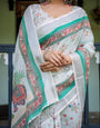 Ivory Pure Cotton Linen Saree with Elephant Motif and Floral Pattern, Green and Pink Borders, and Tassels on Edges.