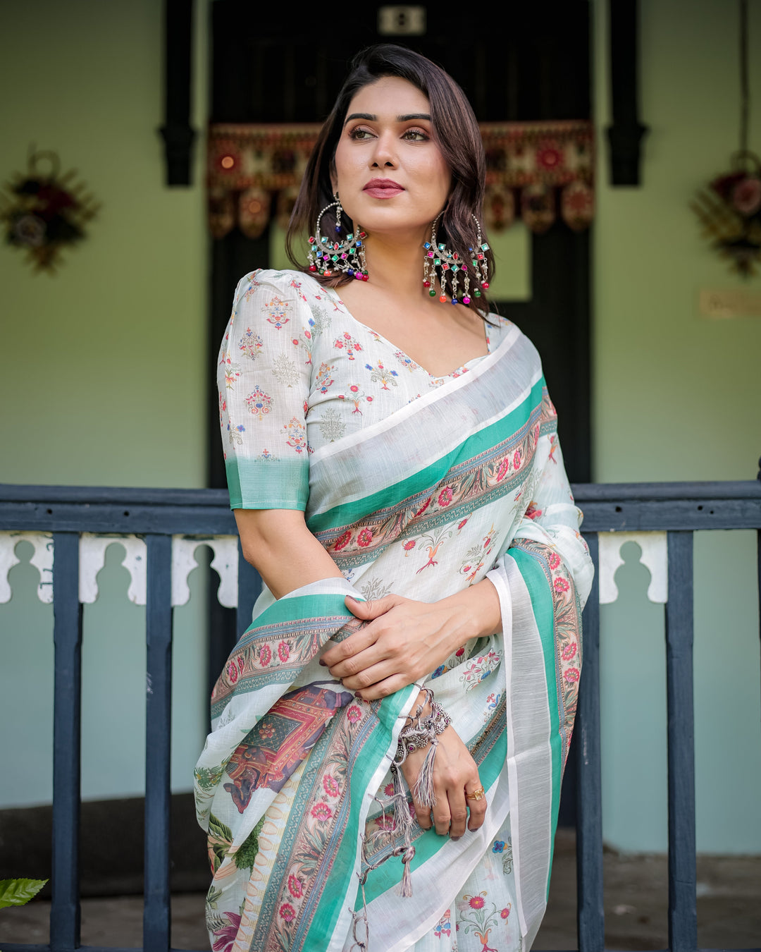 Ivory Pure Cotton Linen Saree with Elephant Motif and Floral Pattern, Green and Pink Borders, and Tassels on Edges.