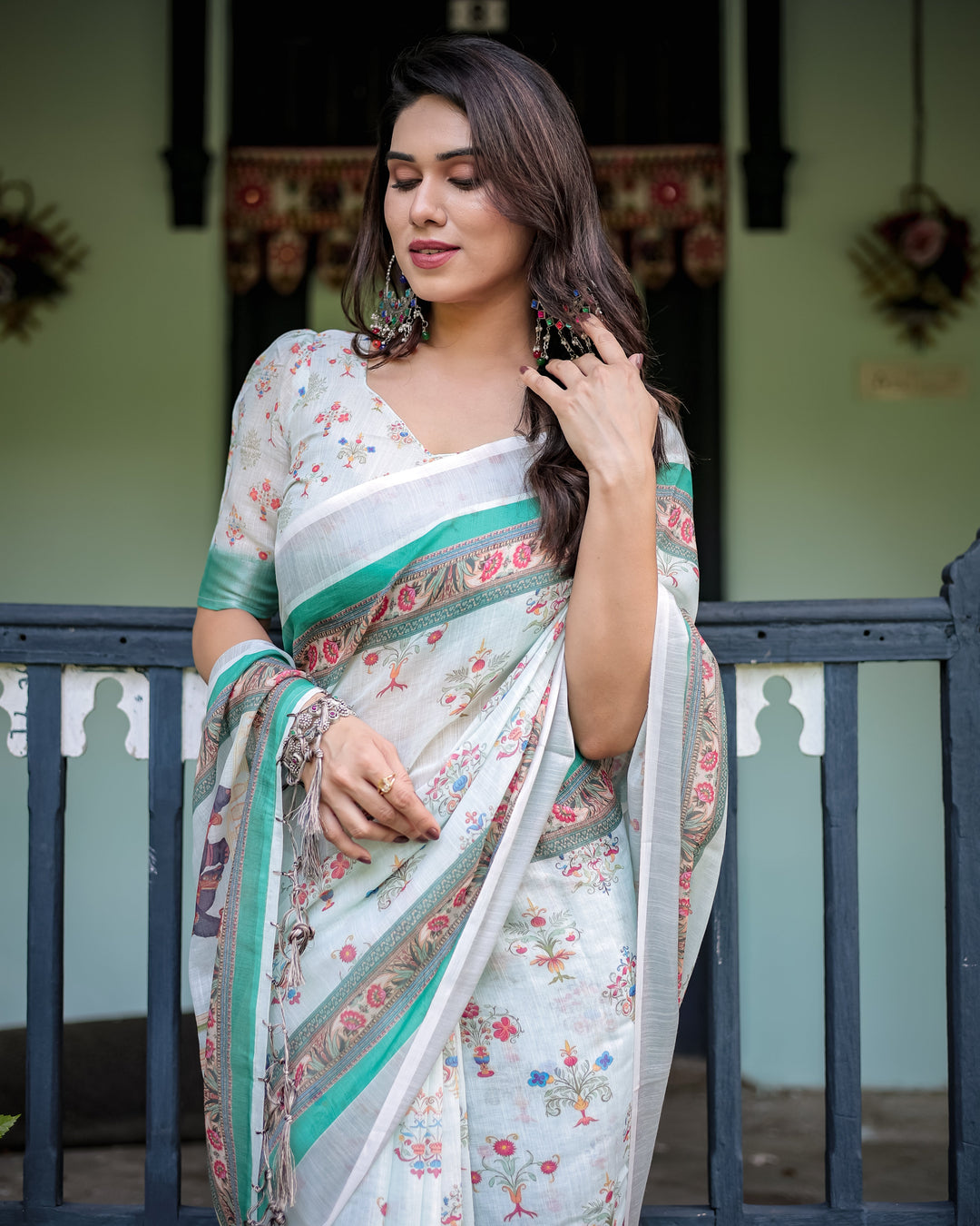 Ivory Pure Cotton Linen Saree with Elephant Motif and Floral Pattern, Green and Pink Borders, and Tassels on Edges.