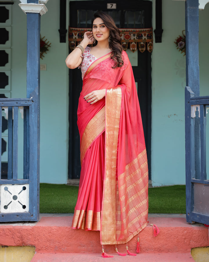 Vibrant Coral Pink Plain Chiffon Saree with Gold Zari Border, Floral Ruffled Blouse & Tassel Detailing