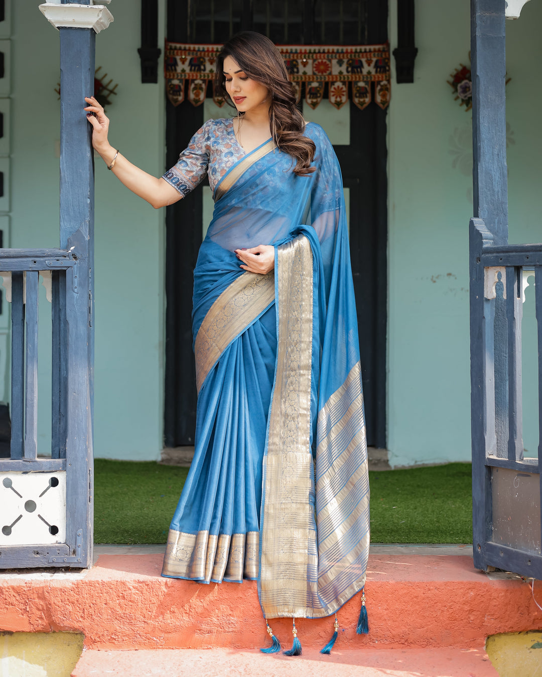 Vibrant Peacock Blue Plain Chiffon Saree with Gold Zari Border, Floral Printed Blouse & Tassel Accents