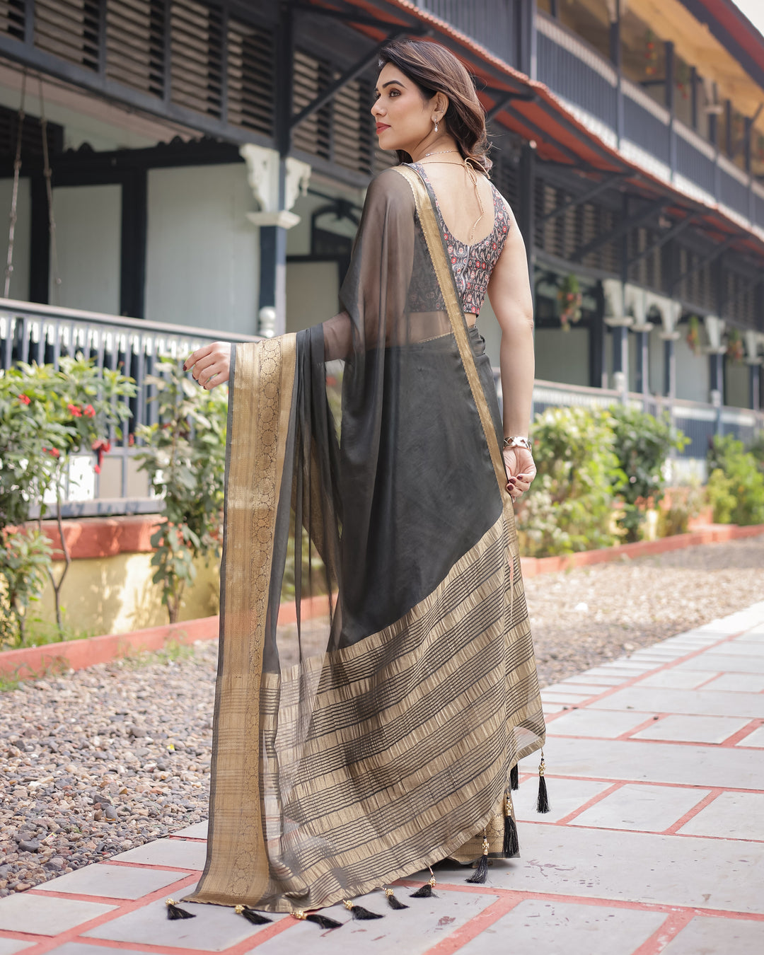 Ethereal Black Plain Chiffon Saree with Gold Zari Border, Floral Printed Blouse & Tassel Detailing