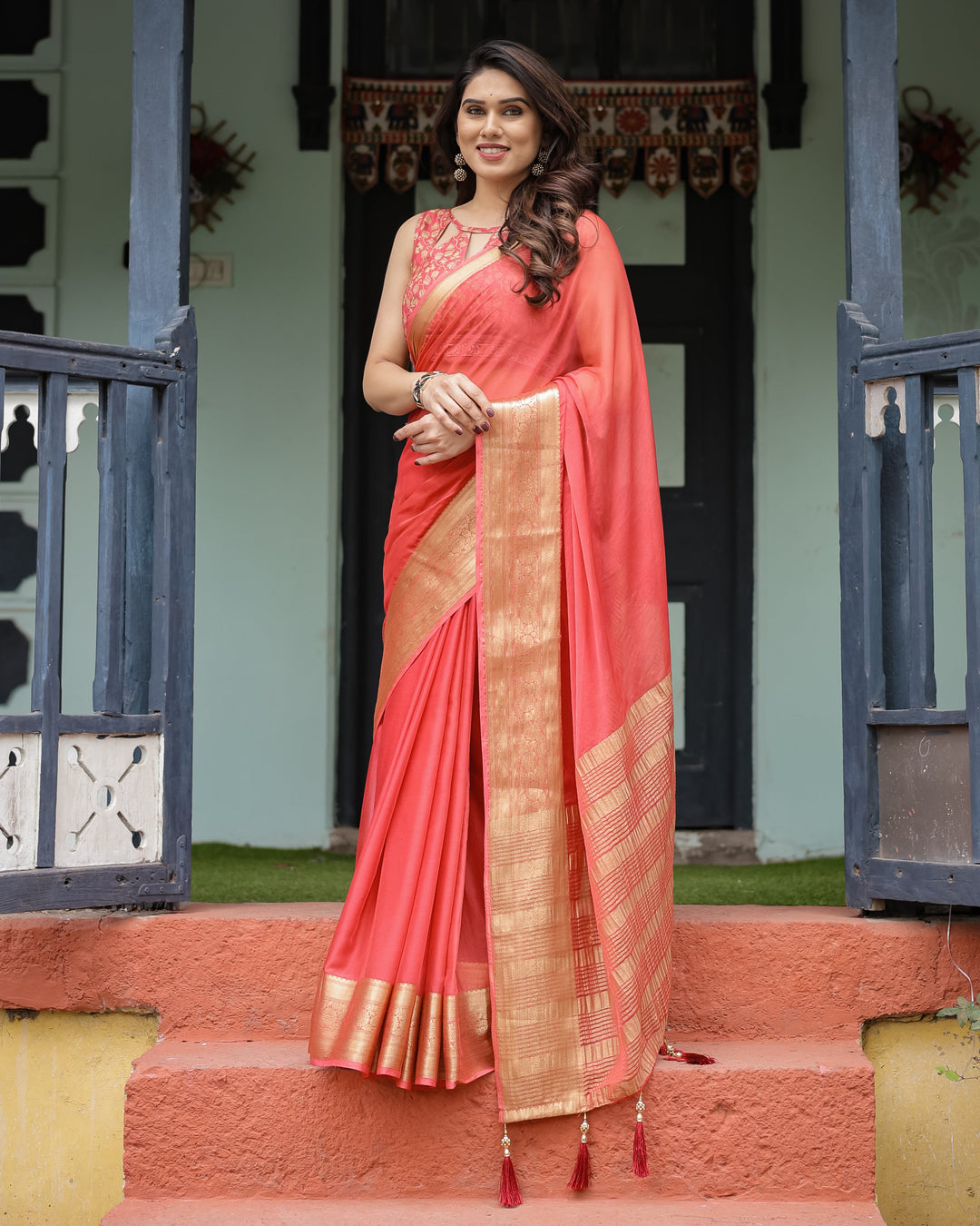 Graceful Coral Pink Plain Chiffon Saree with Gold Zari Border, Floral Embroidered Blouse & Tassel Detailing