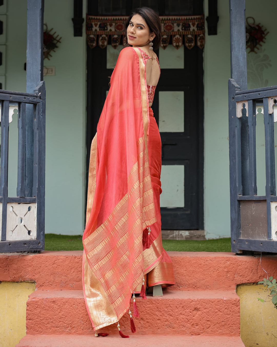 Graceful Coral Pink Plain Chiffon Saree with Gold Zari Border, Floral Embroidered Blouse & Tassel Detailing