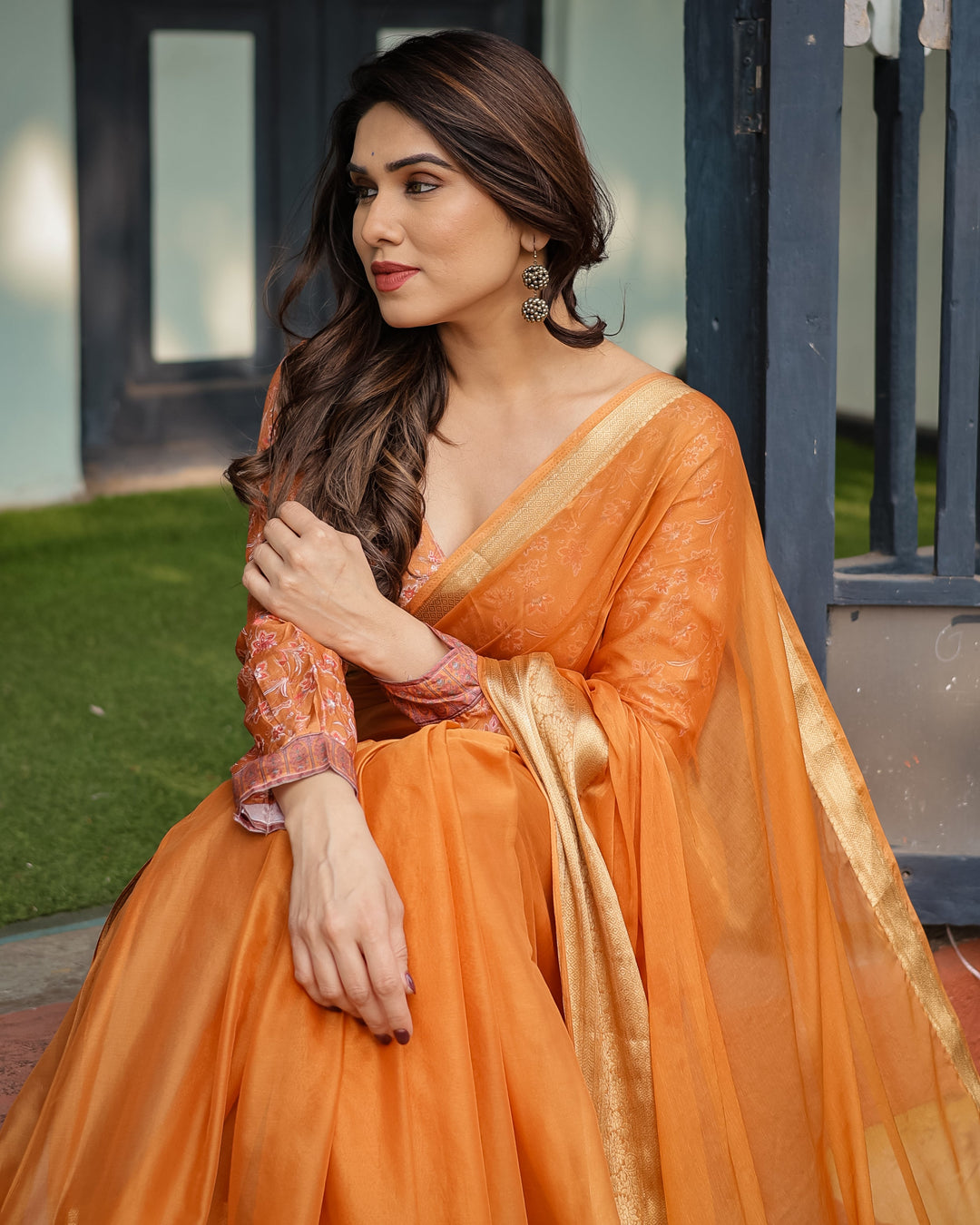 Sunset Orange Plain Chiffon Saree with Gold Zari Border, Floral Embroidered Blouse & Tassel Detailing