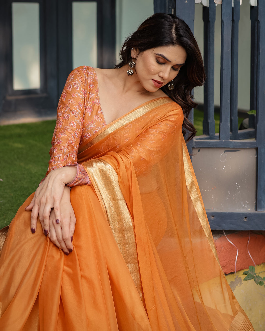 Sunset Orange Plain Chiffon Saree with Gold Zari Border, Floral Embroidered Blouse & Tassel Detailing