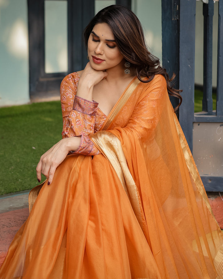 Sunset Orange Plain Chiffon Saree with Gold Zari Border, Floral Embroidered Blouse & Tassel Detailing