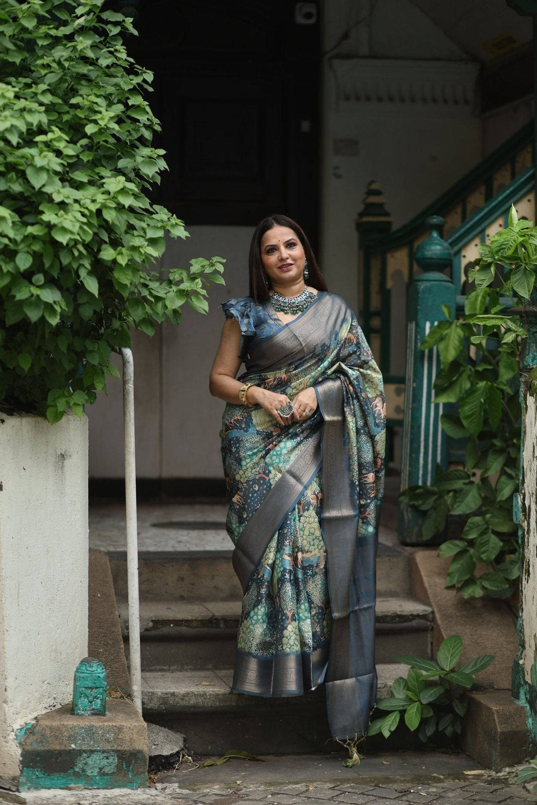 Elegant Teal Blue Banarasi Silk Saree with Forest-Inspired Motifs and Tassels