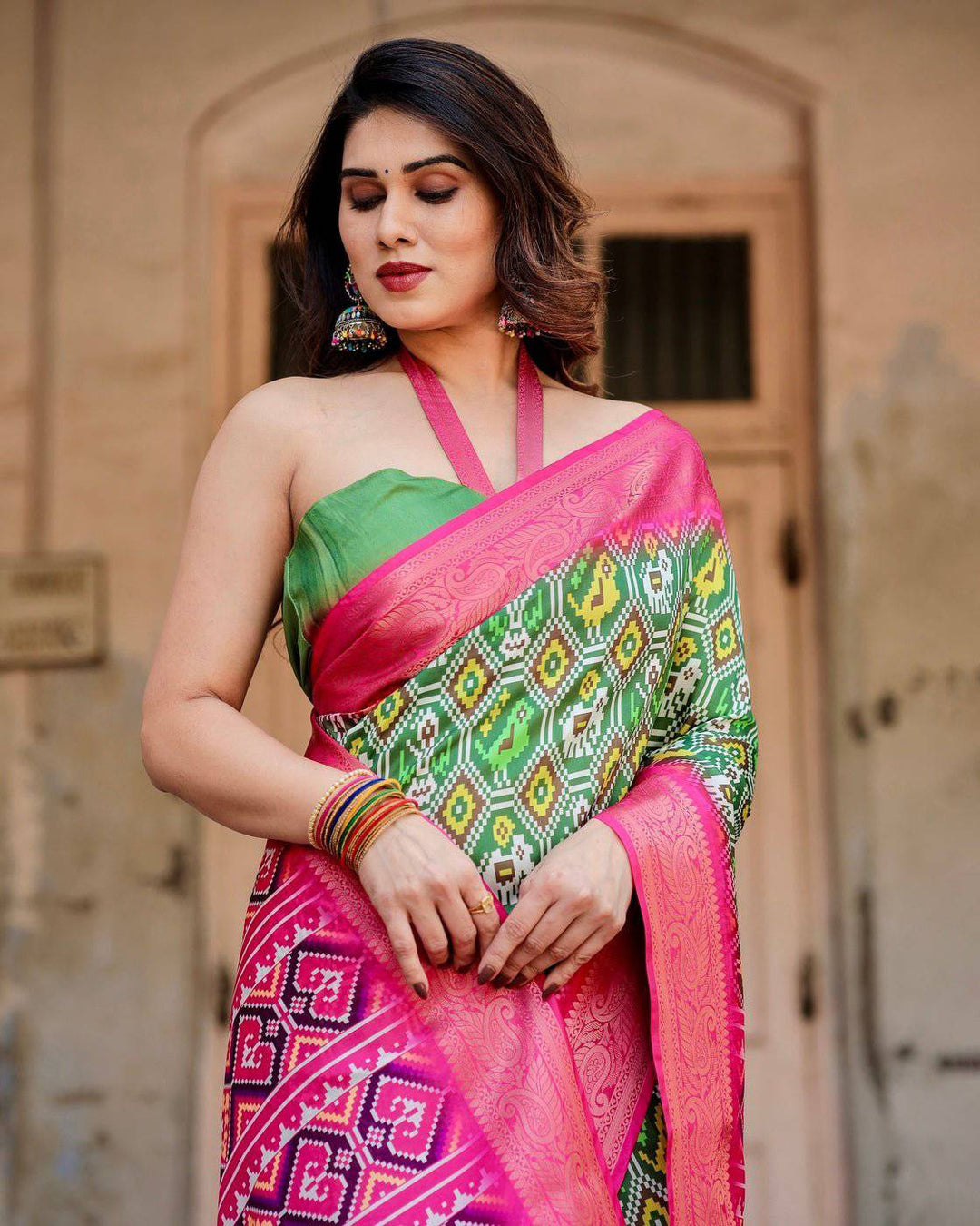 Green and Pink Tussar Silk Saree with Vibrant Ikat Patterns and Zari Border