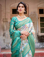 Graceful Green Banarasi Silk Saree with Vibrant Motifs and Zari Woven Pallu